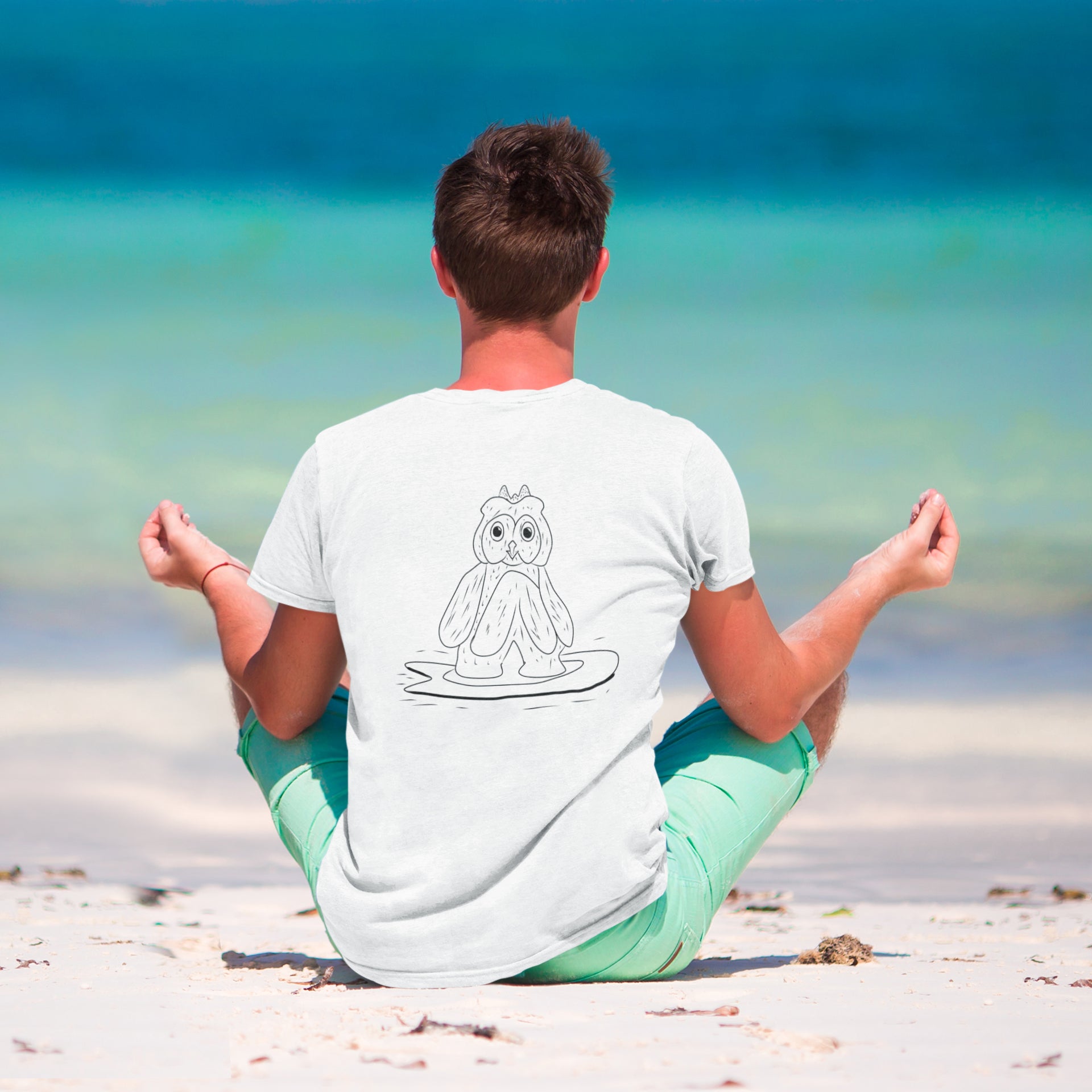 Surfing Owl Line | 100% Organic Cotton T Shirt worn by a man on the beach