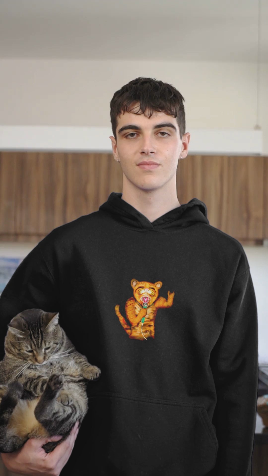 Cat rocker | Sustainable Hoodie worn by a man carrying a cat