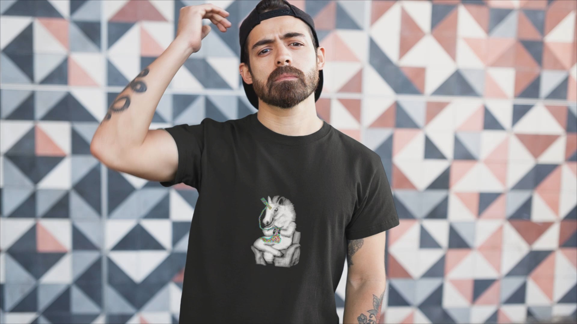 Knitting Unicorn | 100% Organic Cotton T Shirt  worn by a man by a wall