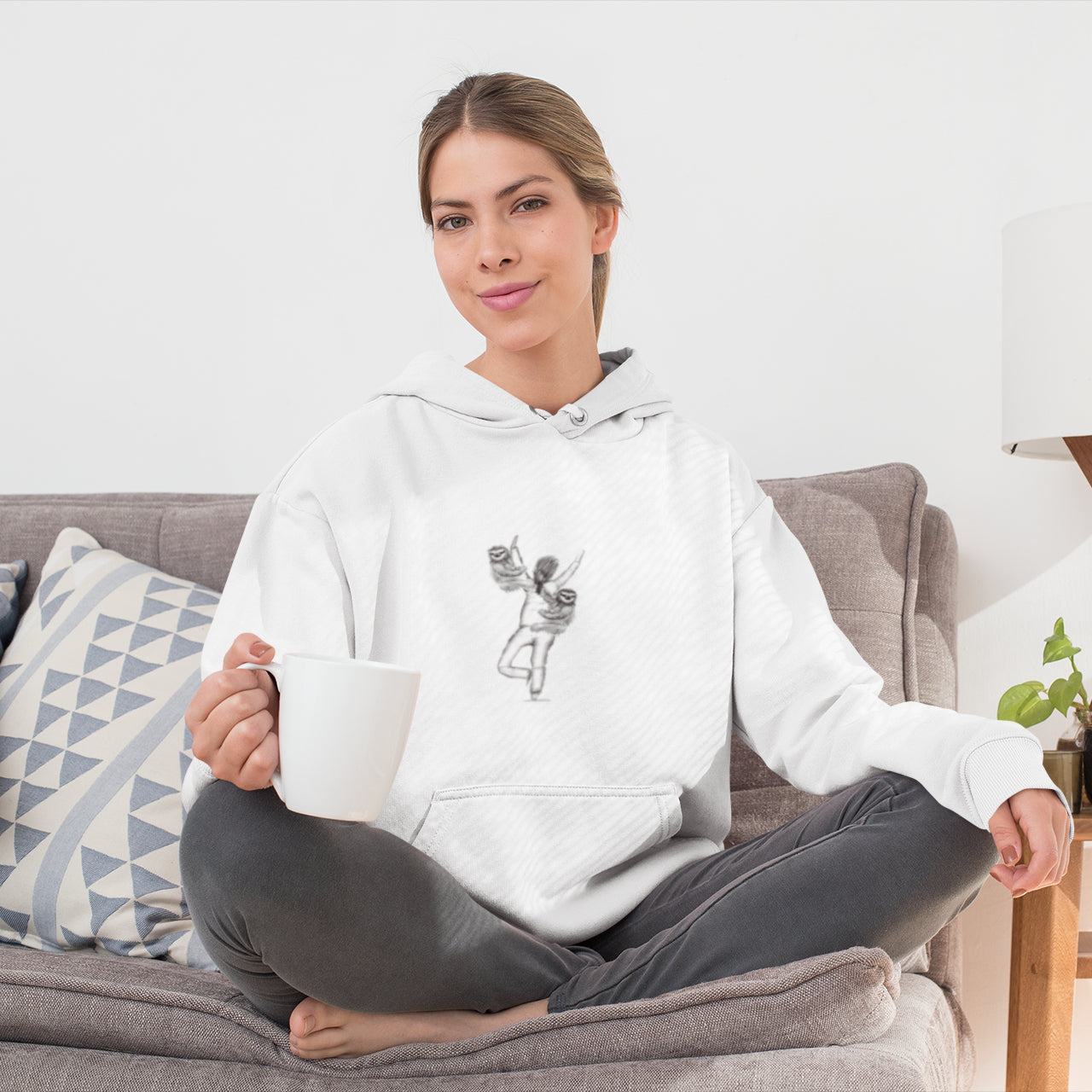 Yoga Sloth | Sustainable Hoodie One Pouch worn by lady on sofa