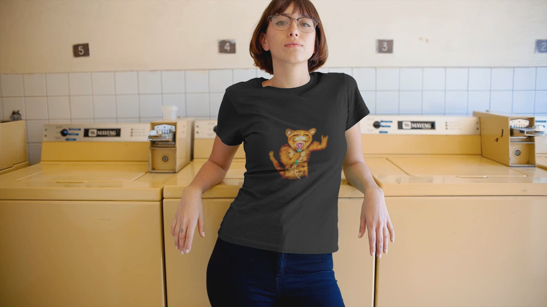 Cat Rocker | 100% Organic Cotton T Shirt worn by a woman by a washing machine
