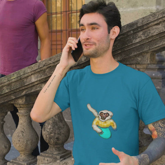 Gibbon Surfing | 100% Organic Cotton T Shirt worn by a man at pride