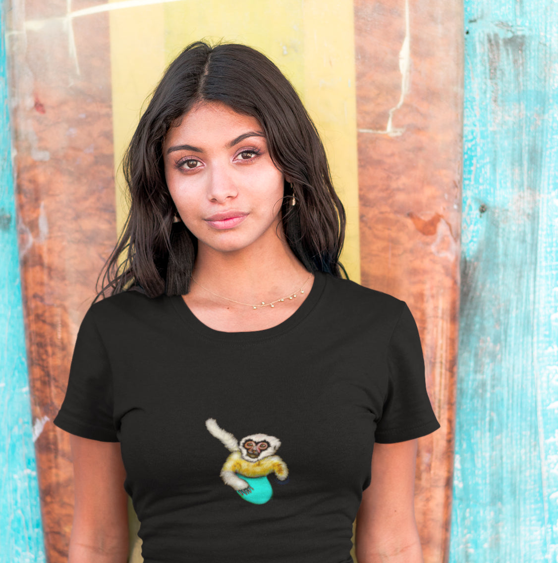 Gibbon Surfing | 100% Organic Cotton T Shirt worn by woman in front of surf board