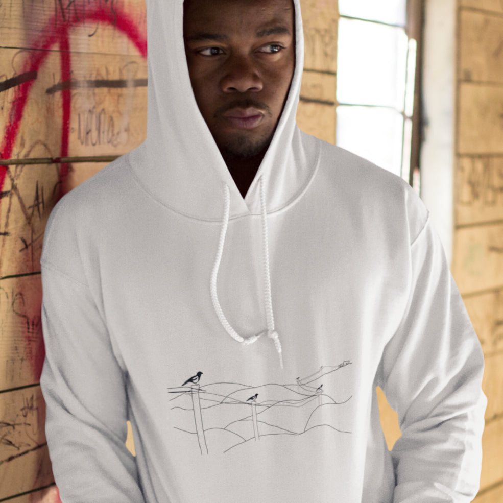 Man wearing a Magpies on a wire sustainable vegan hoodie