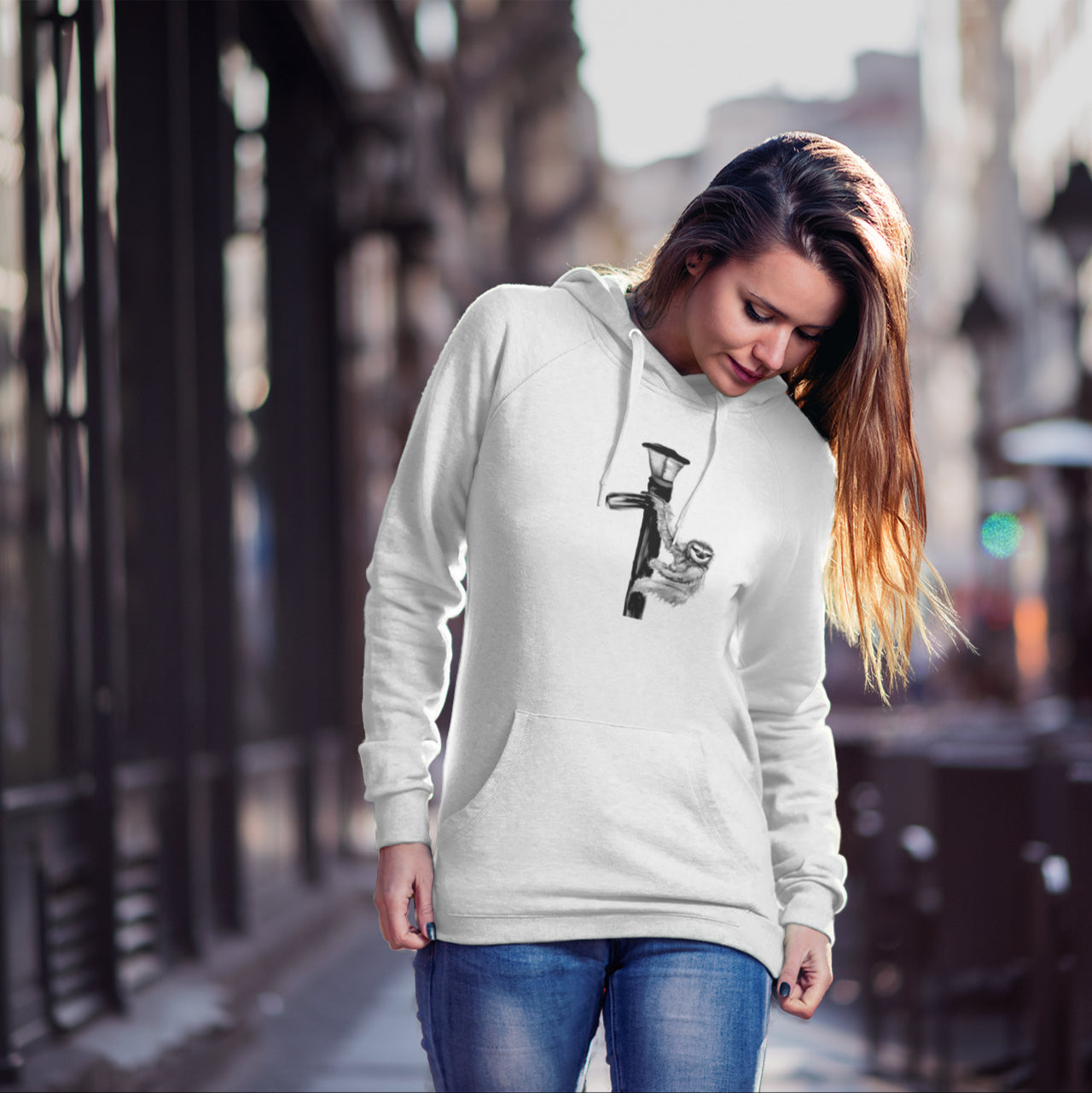 Woman wearing a Sloth on a lamp post sustainable vegan hoodie