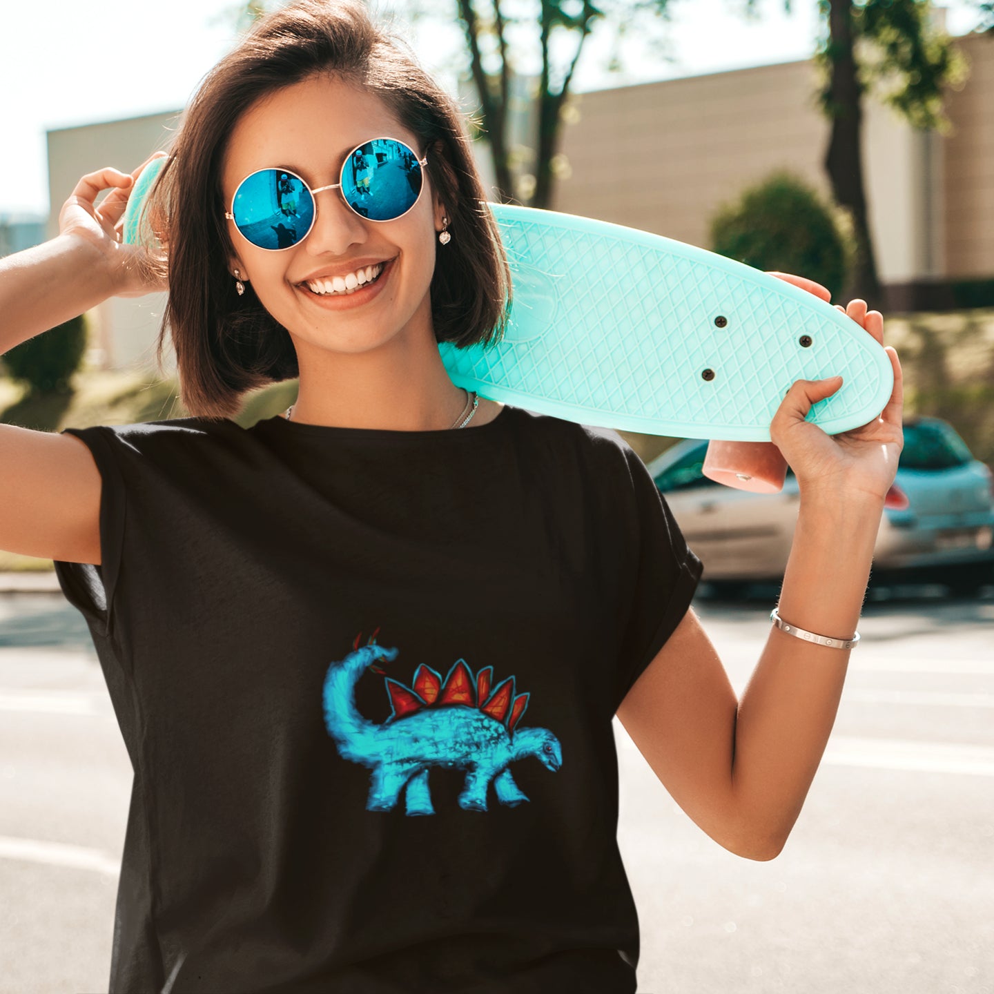 Dinosaur Stegosaurus | 100% Organic Cotton T Shirt worn by a woman with a skateboard