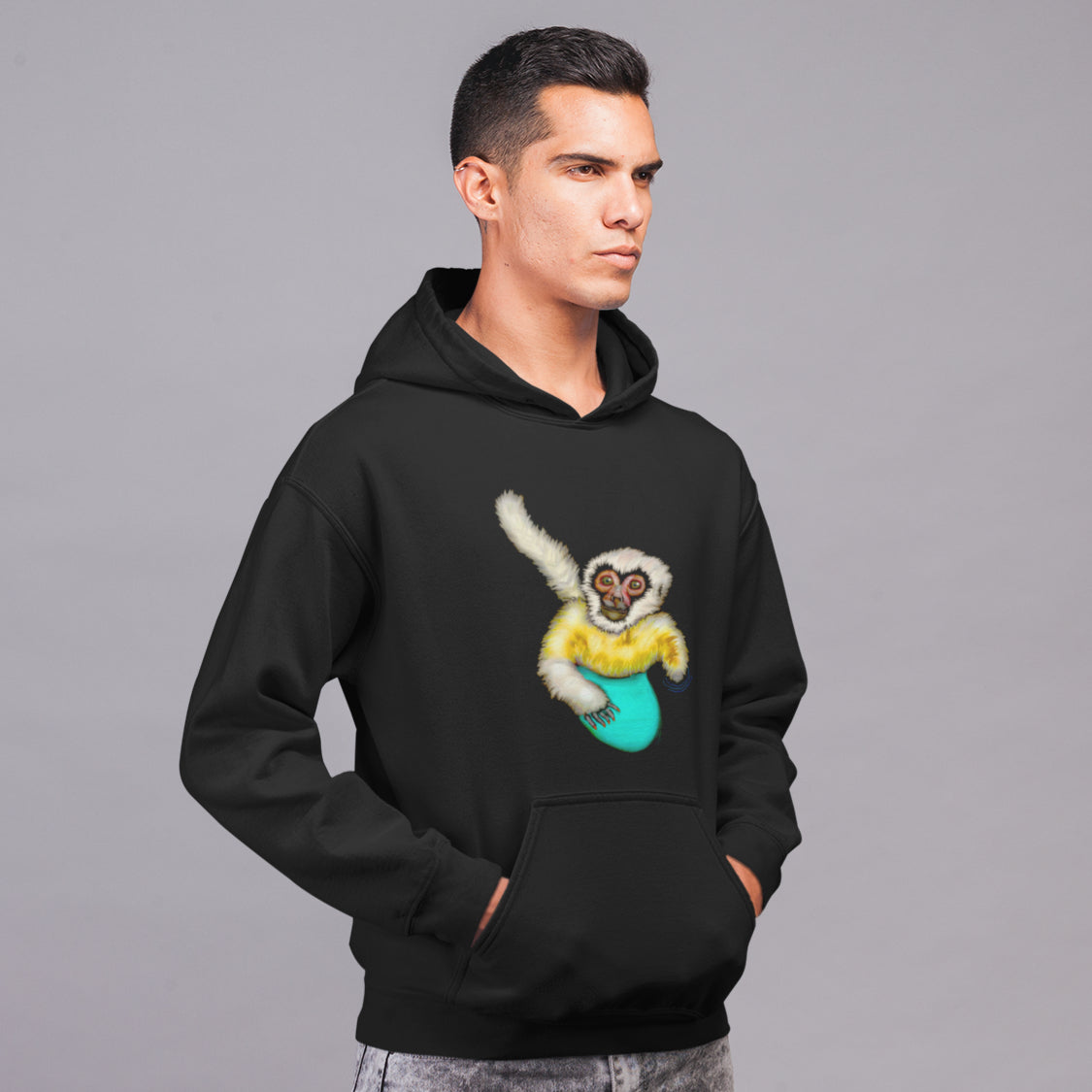 Man wearing a Surfing white cheeked gibbon sustainable vegan hoodie
