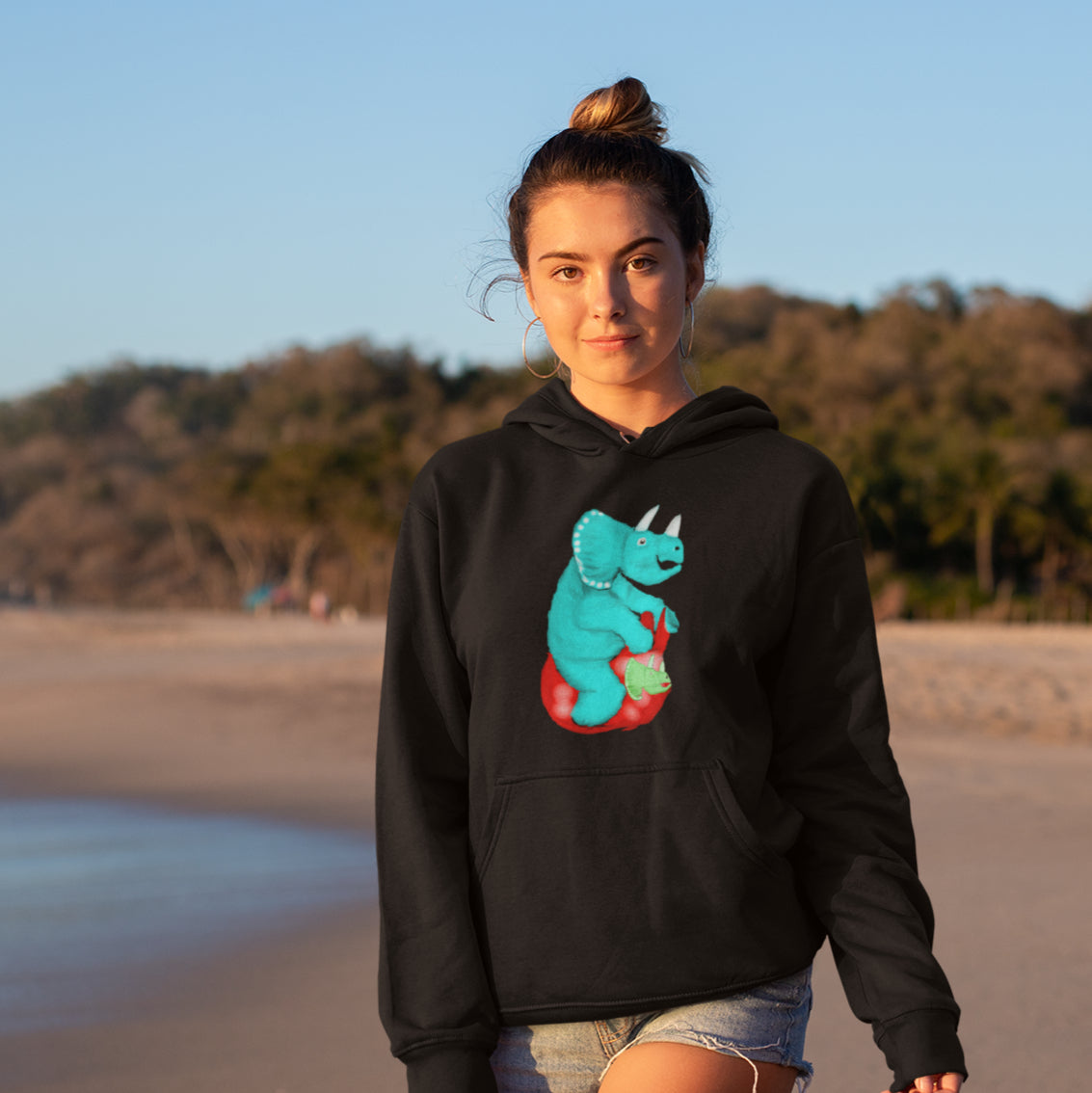 Woman wearing a triceratops on a space hopper sustainable vegan hoodie