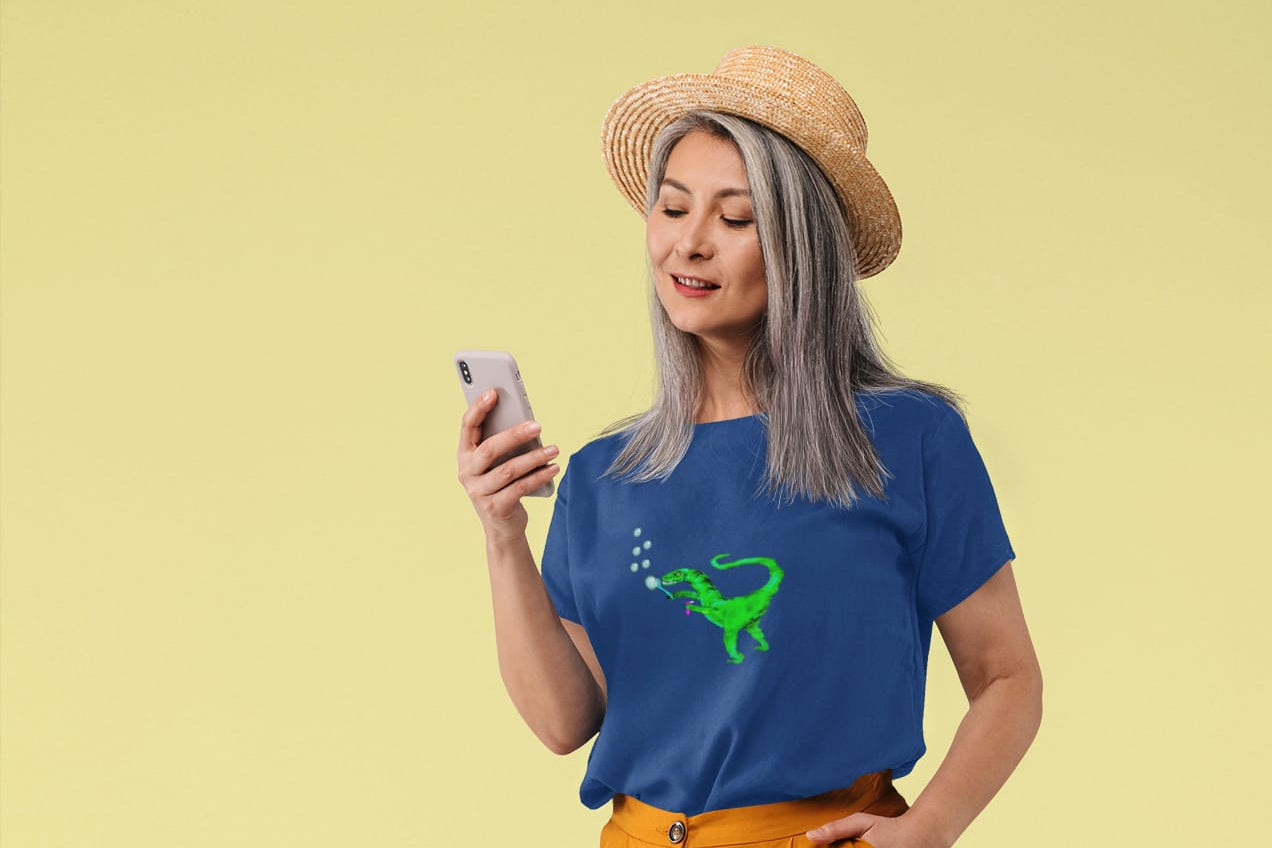 Woman wearing a blue t-shirt with a green graphic and yellow pants, standing against a yellow background.