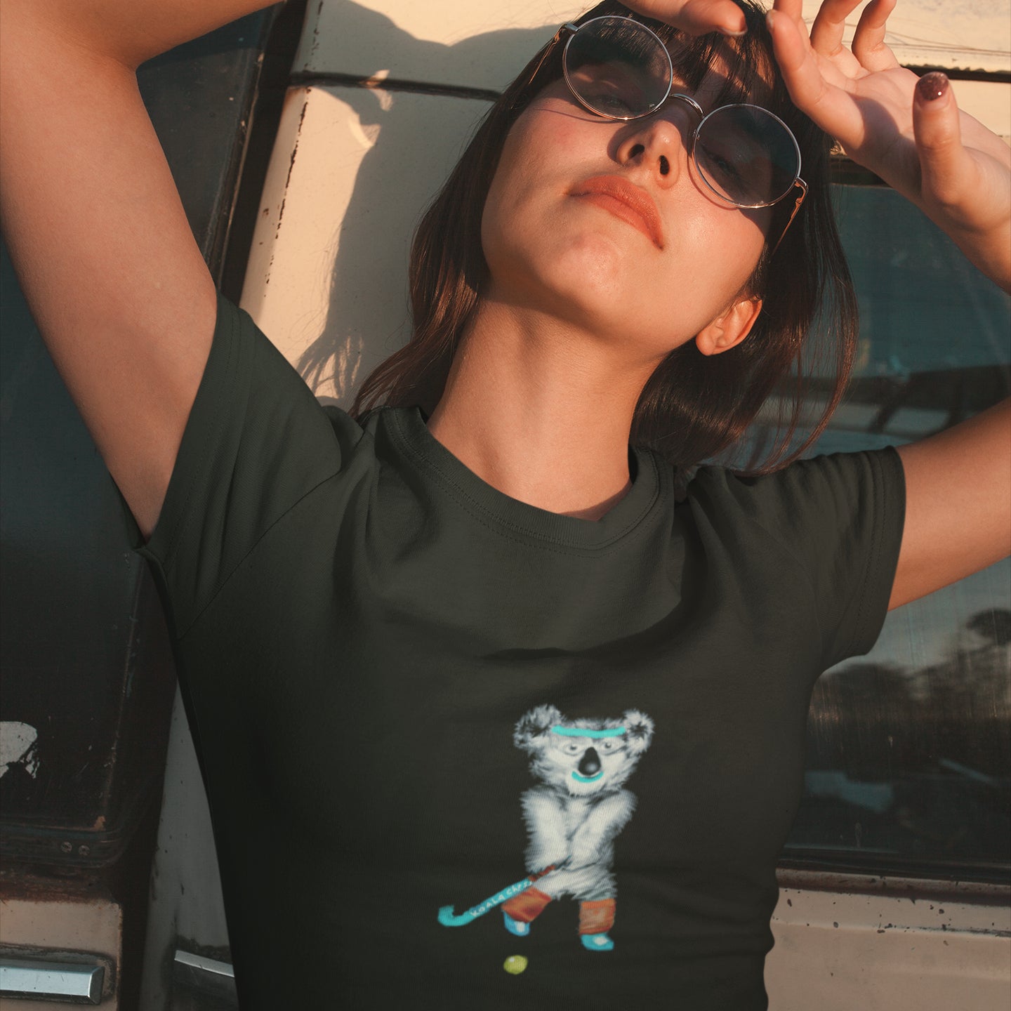 Koala playing hockey | Women's 100% Organic Cotton T Shirt worn by a woman