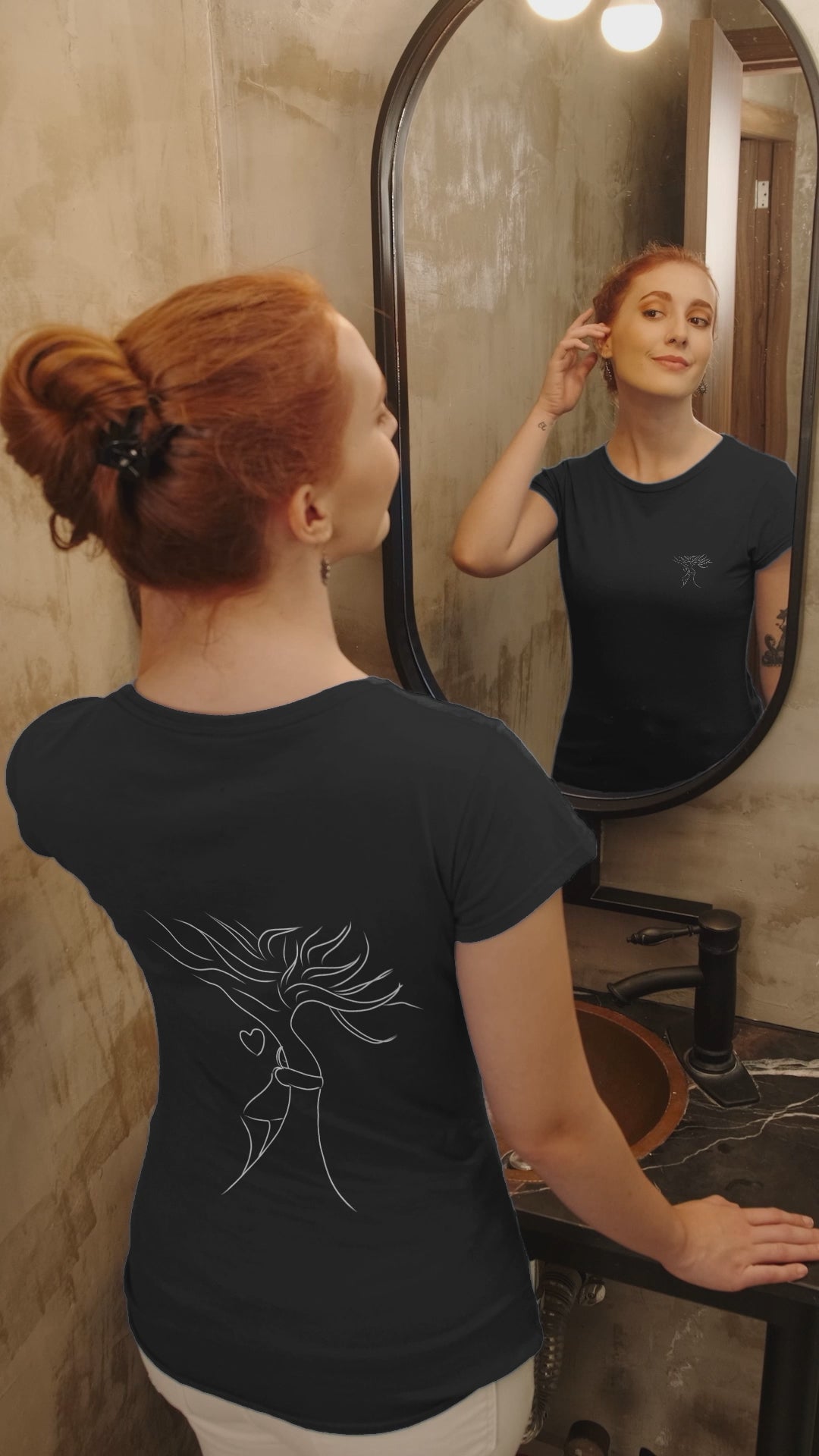 Sustainable Embrace White Tree | 100% Organic Cotton T Shirt worn by woman looking into a mirror