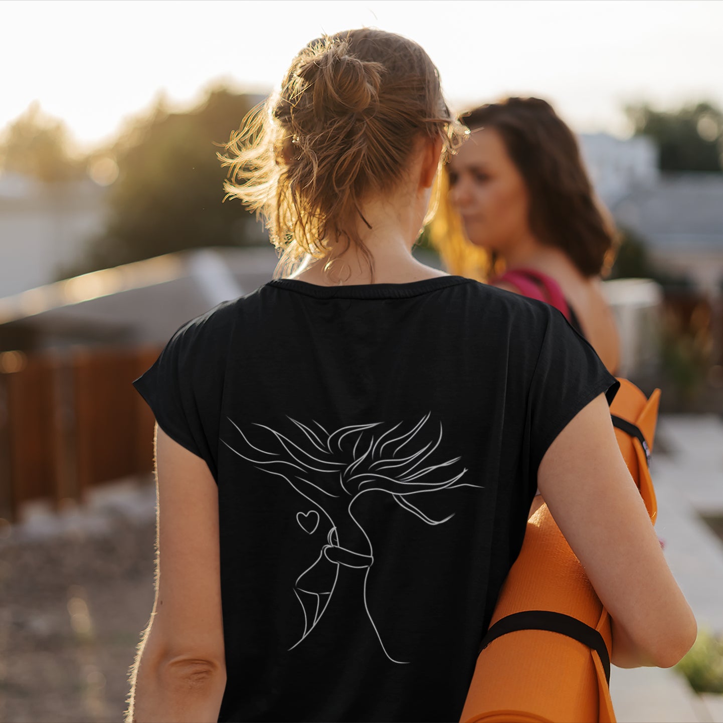 Sustainable Embrace White Tree | 100% Organic Cotton T Shirt worn by a woman carrying a yoga mat