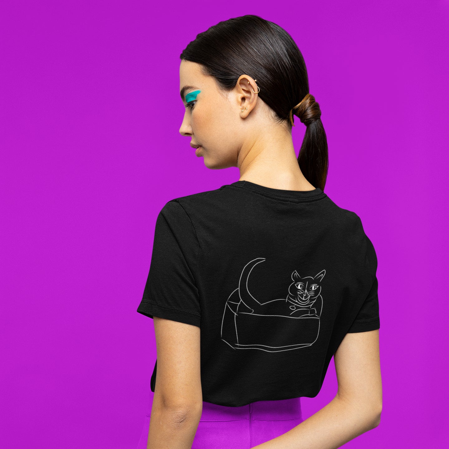 Cat white | 100% Organic Cotton T Shirt worn by a woman against a purple background