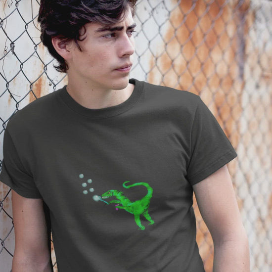 Dinosaur Velociraptor | Organic Cotton T Shirt worn by a man leaning by a fence