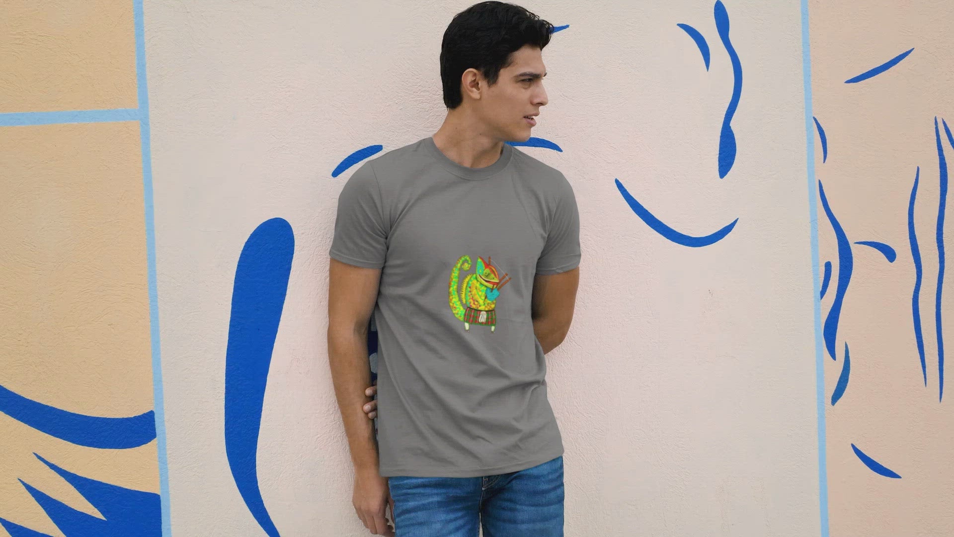 Bagpiper Chameleon | 100% Organic Cotton T Shirt worn by a man in front of a wall