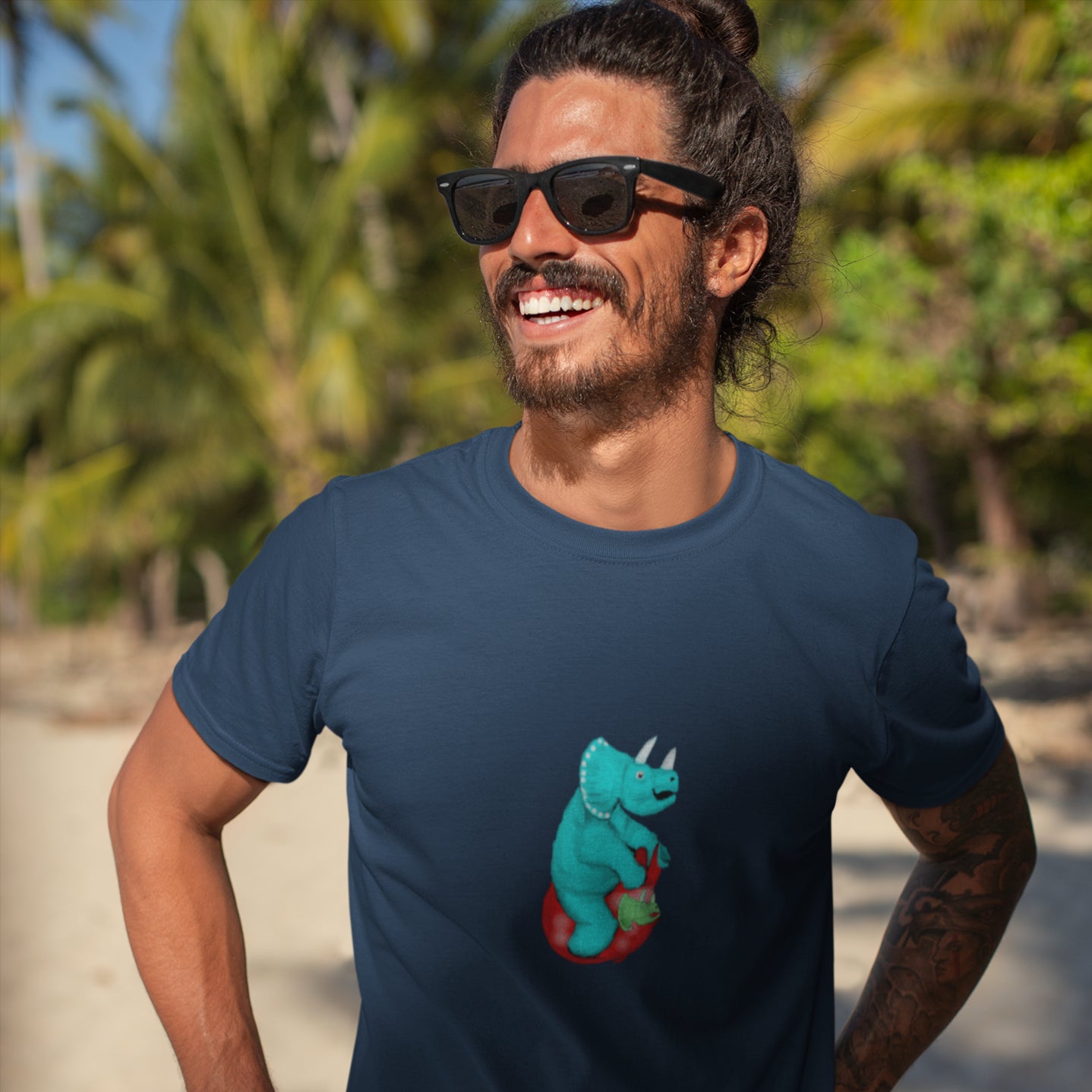 man wearing a Dinosaur vegan organic cotton t-shirt triceratops on a space hopper 