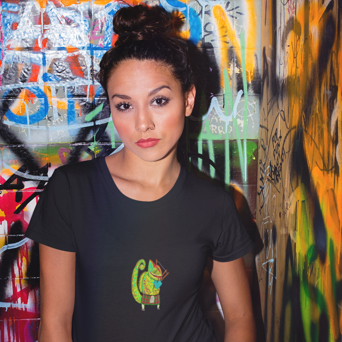 Bagpiper Chameleon | Women's 100% Organic Cotton T Shirt worn by a woman in front of a wall