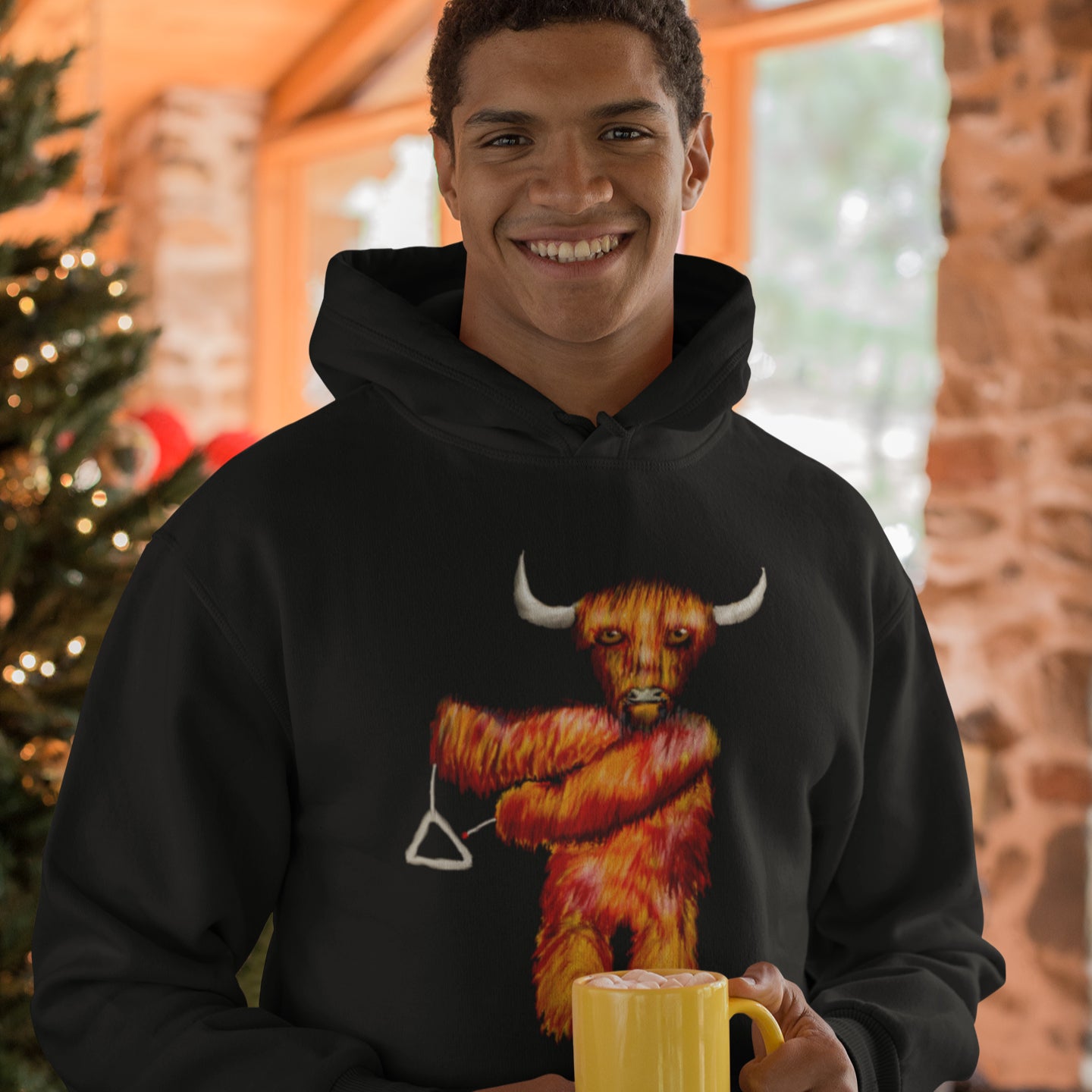 Man wearing a Cow playing the triangle sustainable vegan hoodie