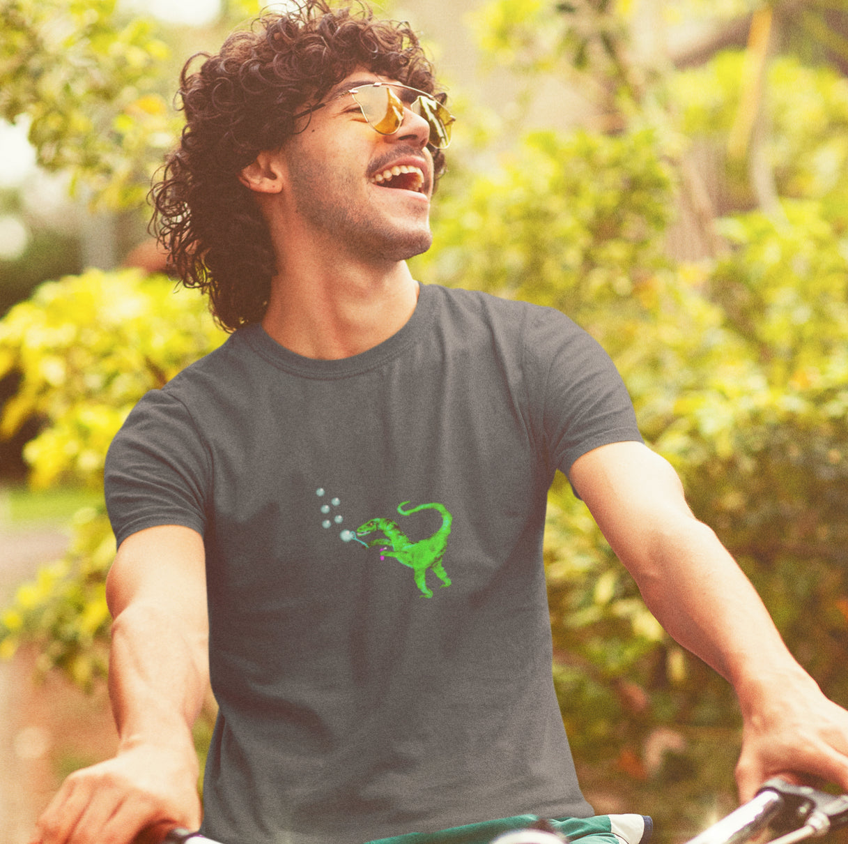 man wearing a Dinosaur velociraptor blowing bubbles vegan organic cotton t-shirt