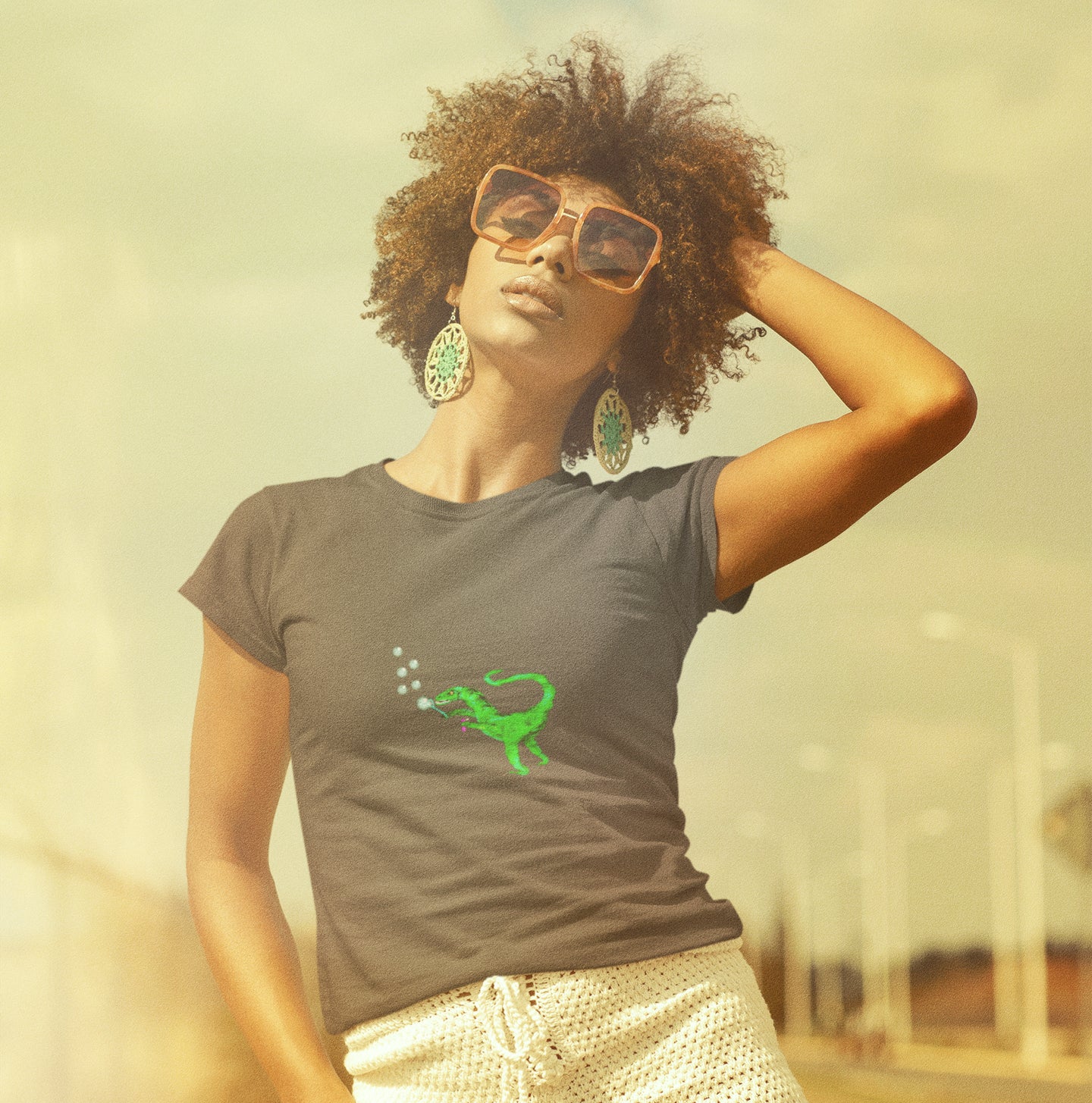 woman wearing a Dinosaur velociraptor blowing bubbles vegan organic cotton t-shirt