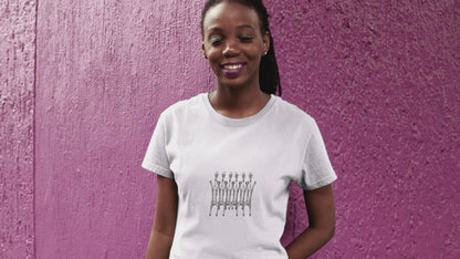 Dancing Giraffes | Women's 100% Organic Cotton T Shirt worn by a woman in front of a purple wall