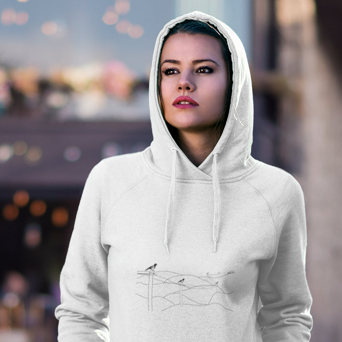 Woman wearing a Magpies on a wire sustainable vegan hoodie