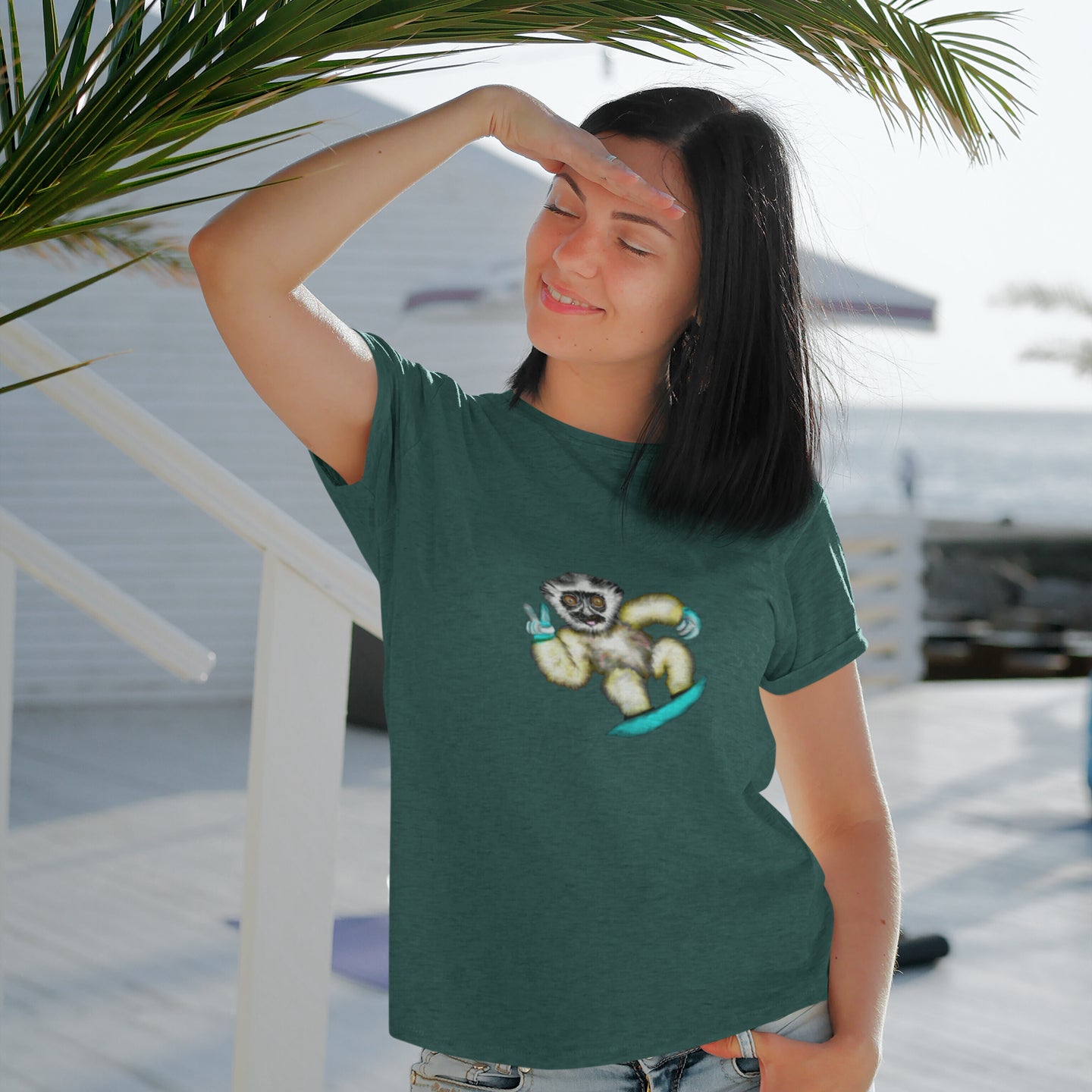 Lemur Snowboarder | 100% Organic Cotton T Shirt worn by a woman on the beach